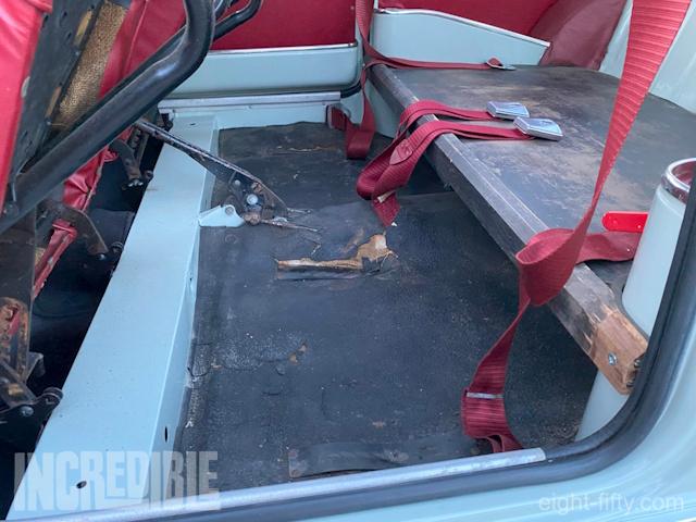 The rear floor mat, though deteriorating, still exists.