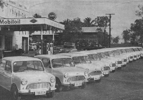 A delivery of 14 Morris 850s for the Northern Territory Administration outside Port Darwin Motors (The BMC Rosette, March 1964).